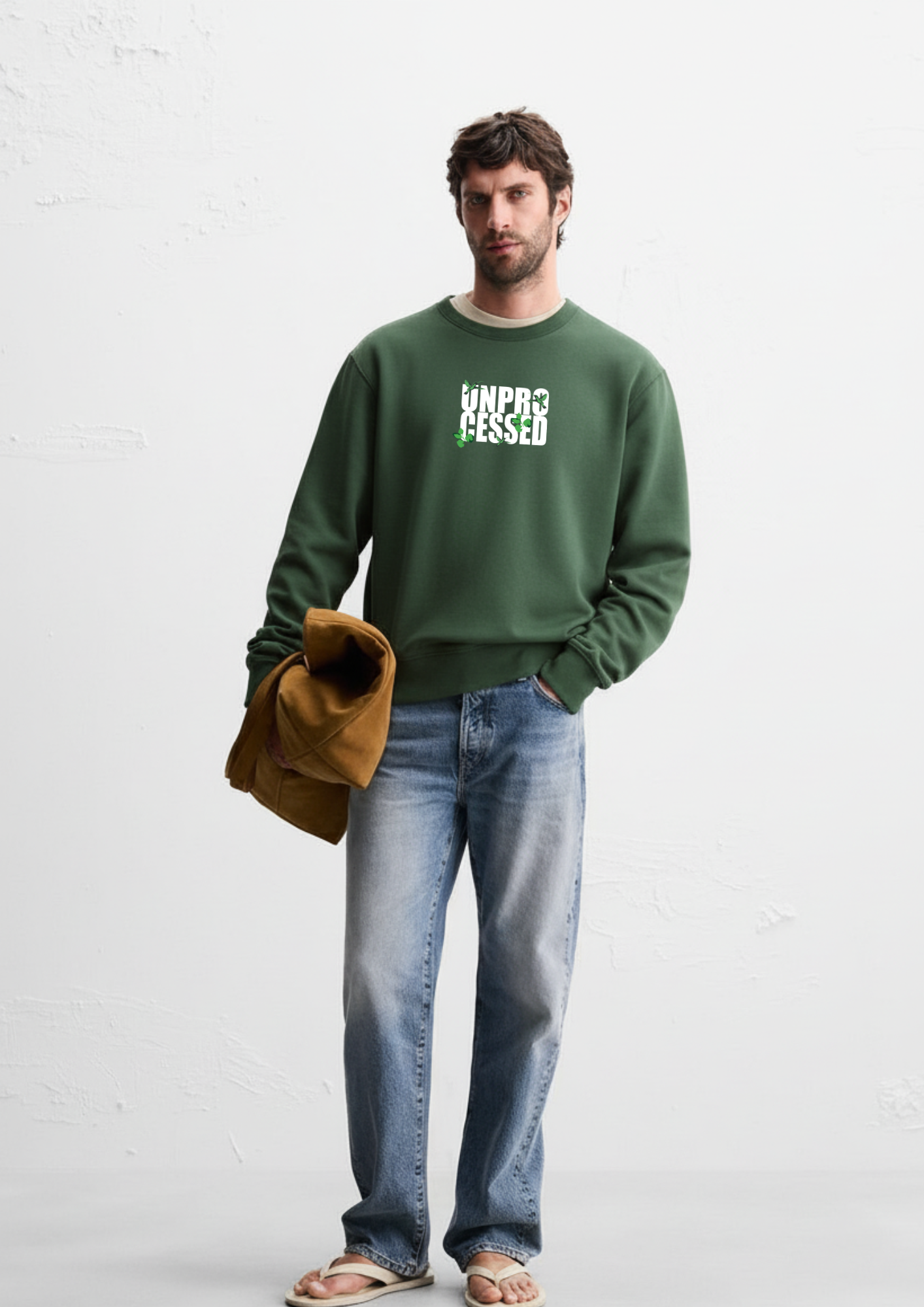 Man wearing a Dark green crewneck sweatshirt and blue jeans